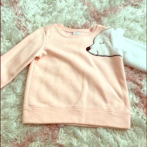 Little girl’s pink pullover sweatshirt.